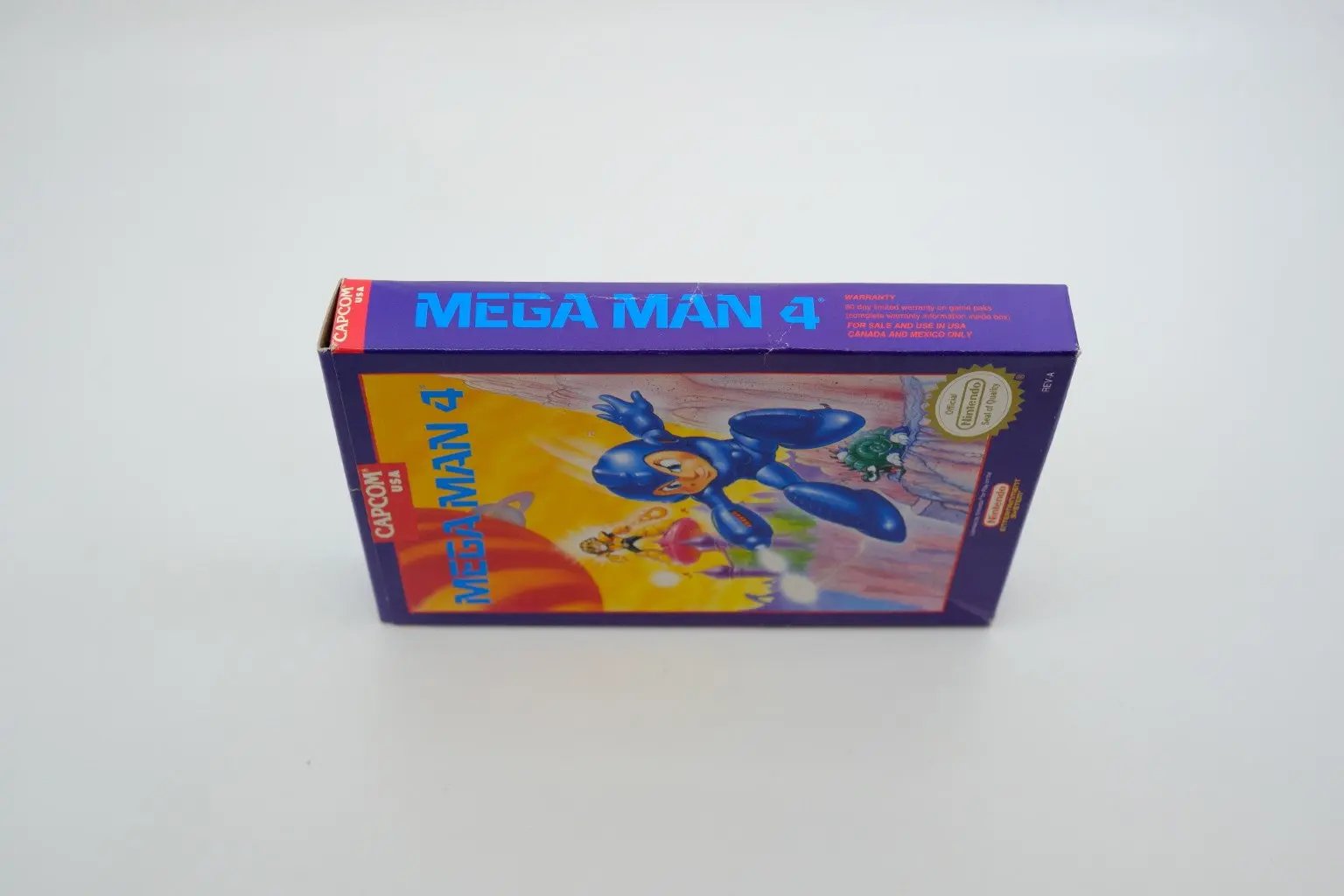 Mega Man 4 – Complete in Box RetroGate - Your Gateway to Classic Gaming